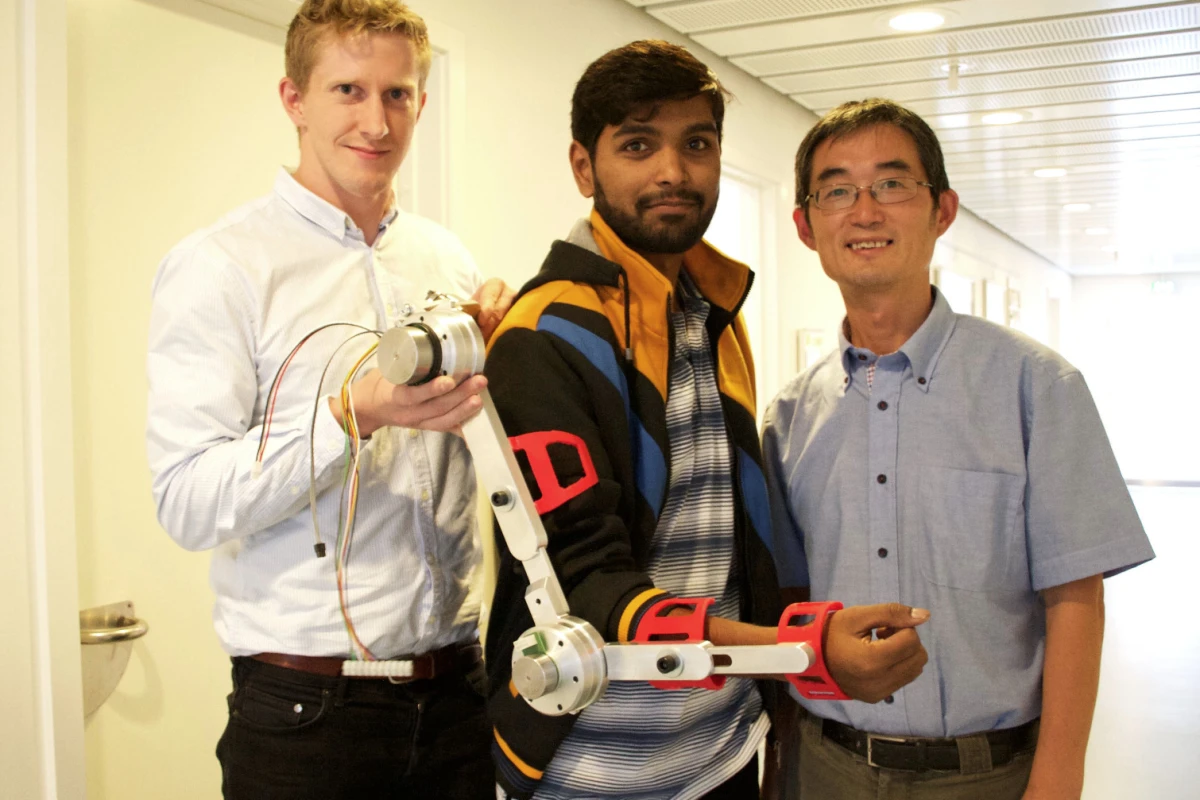 Aalborg University researchers Simon Christensen (left), Muhammad Raza Ul Islam and Shaoping Bai, with an arm brace designed for the AXO Suit