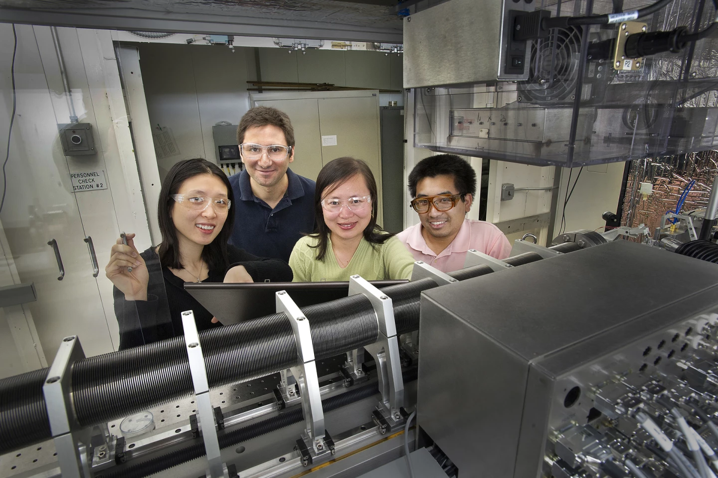 Collaborators from Photon Sciences and Sustainable Energy Technologies stand behind the new transmission x-ray microscope (TXM). From left: Yu-chen Karen Chen-Wiegart, Can Erdonmez, Jun Wang (team leader), and Christopher Eng. (Photo: Brookhaven National Laboratory)