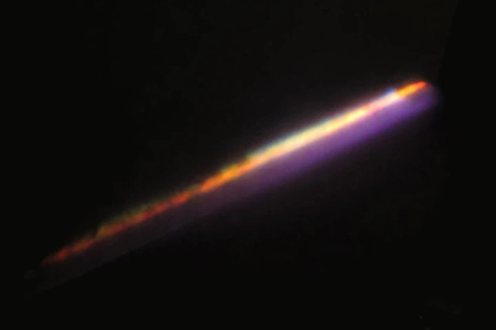 A light pulse fired from a 10 TW laser, dispersing into water vapor – the blue glow is laser light and the source of the other colors is mainly plasma filament arising as a result of ionized matter (Photo: IPC PAS)