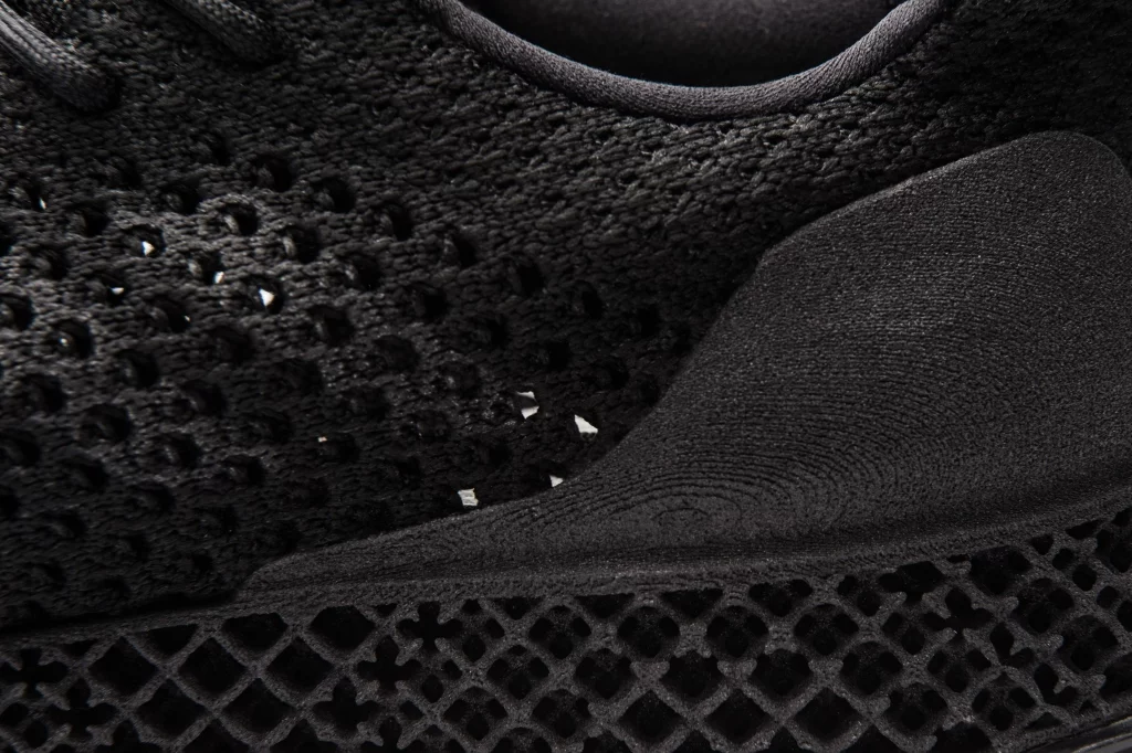 A 3D-printed web structure with varying density and a 3D-printed heel counter make up part of the shoe