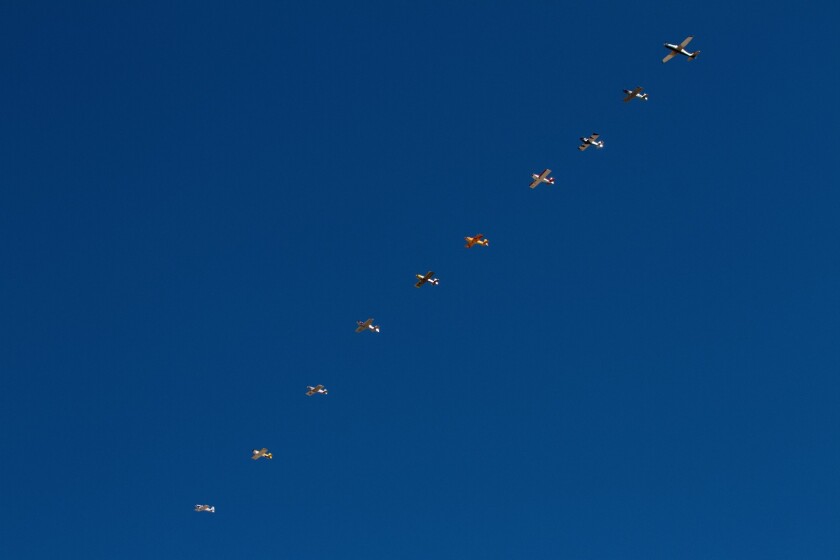 Classes that don't start gridded up on the runway line up in the air. The jet on the right is the pace plane, and the race starts when it pulls back and flies up