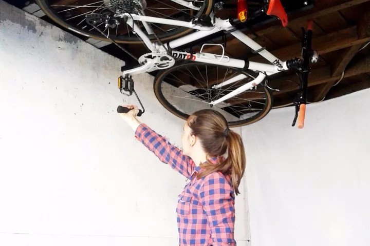 The Hide-A-Ride rack stores bikes parallel to the ceiling