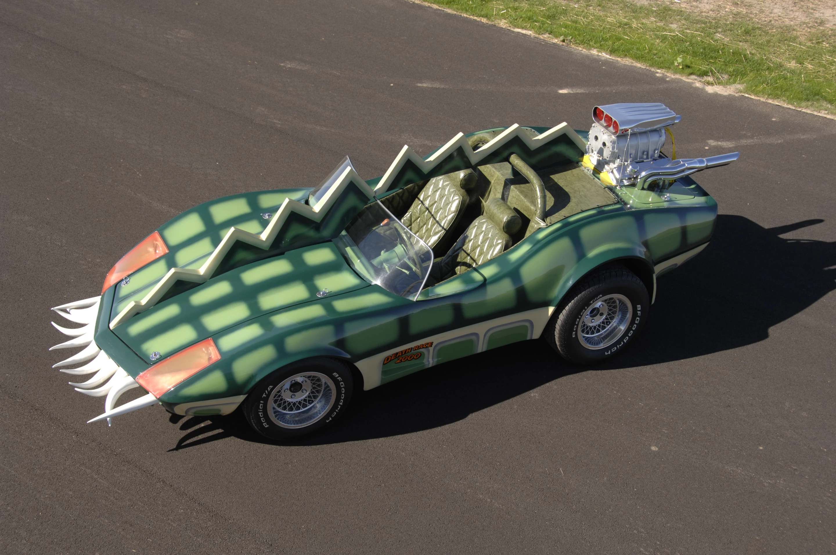 The car that is coming to auction is the Alligator Corvette driven by Carradine in Death Race 2000 (1975). The one-of-a-kind “alligator” Corvette (it's actually a Volkswagen chassis with an air-cooled Corvair motor), is expected to fetch between $20,000 and $25,000, despite the fact it got lots of screen time as Carradine (Frankenstein) fights against his deadly rival Stallone (Machine Gun Joe).