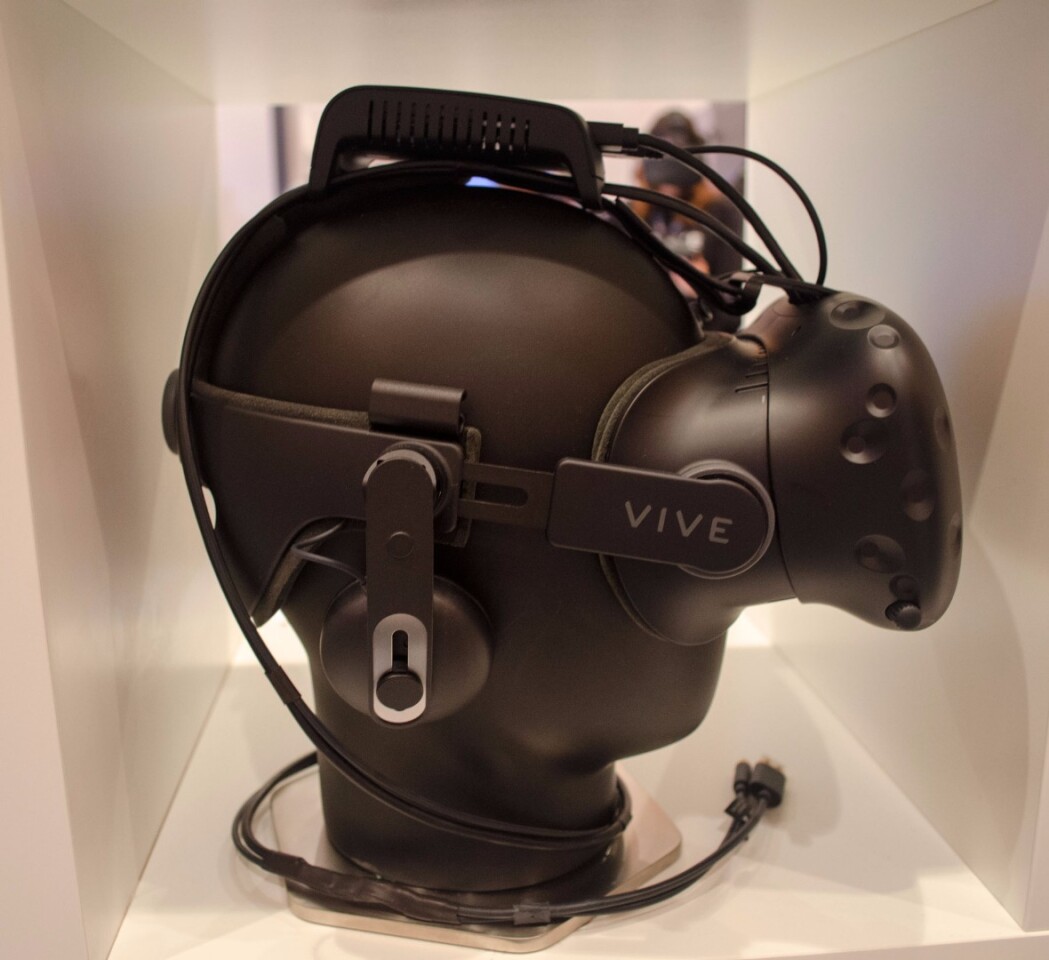 The TPCAST wireless adapter, mounted on top of the HTC Vive