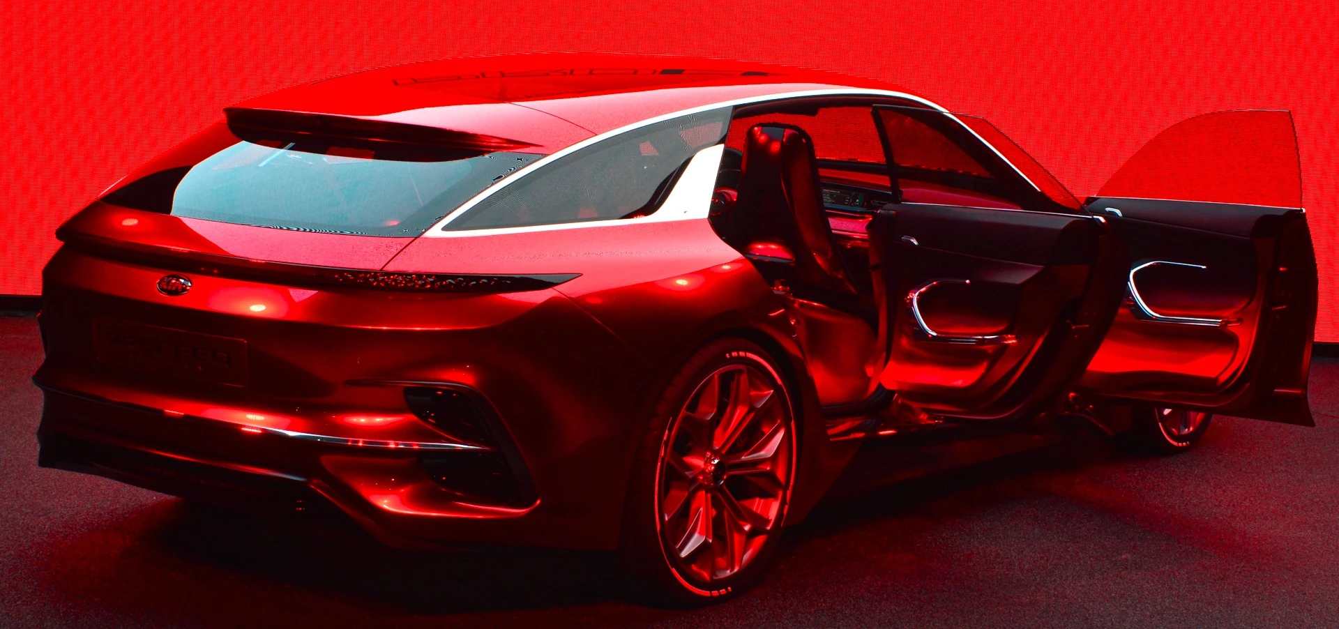 We really aren't sure why Kia decided to put a red backdrop behind the red Proceed, but we would have preferred it didn't