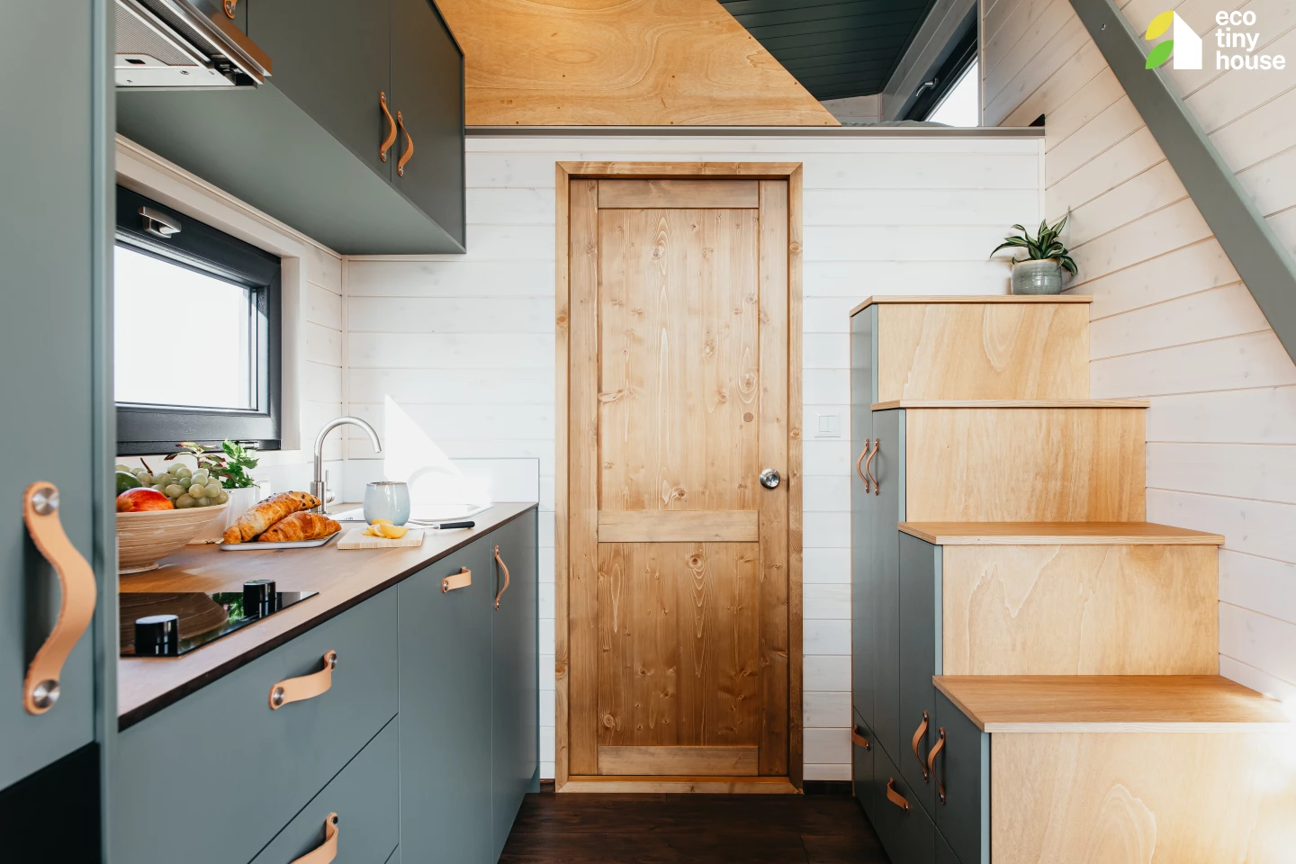 The Tiny Getaway's main bedroom is situated in the loft and is reached by storage-integrated staircase