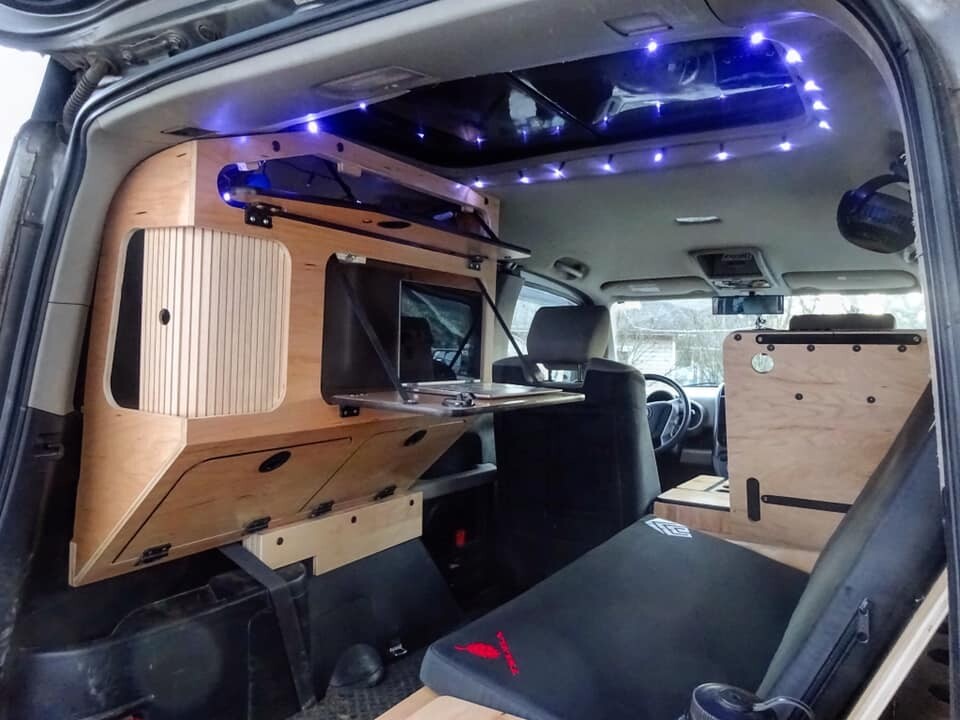 Fifth Element's modular Honda Element camper kit creates a dining nook/mobile office and folds into a double bed