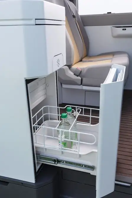 Instead of a single refrigerator box, VW has an under-counter fridge drawer and an overhead fridge cabinet
