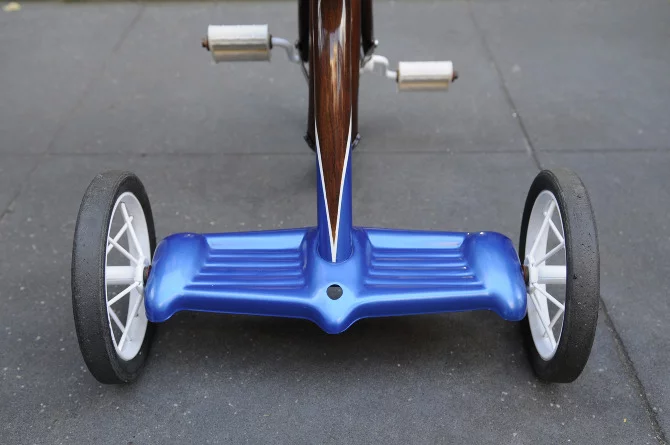 New Zealand's Rob Pollock hand-paints clients' bicycle (or tricycle) frames with a faux woodgrain finish