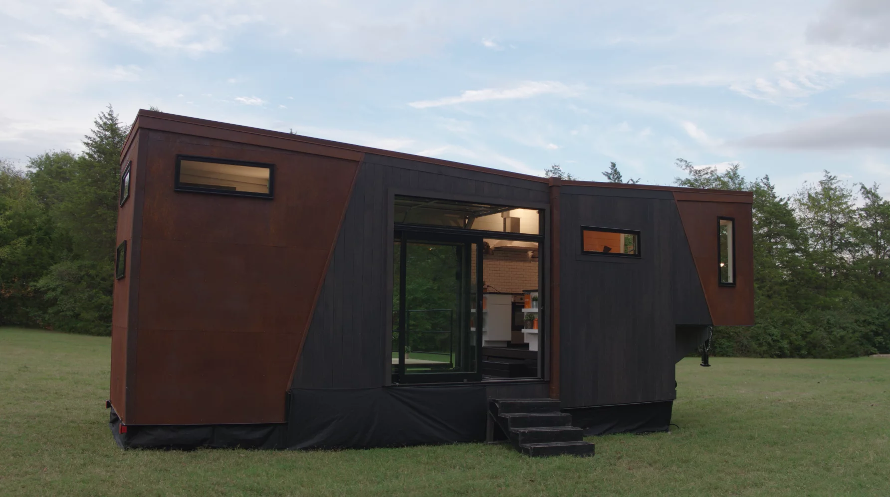 The Home That Runs on Dunkin' is reached by a small staircase and entered by glass sliding doors