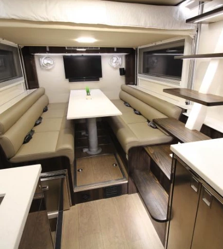 The dining area includes a TV and speakers