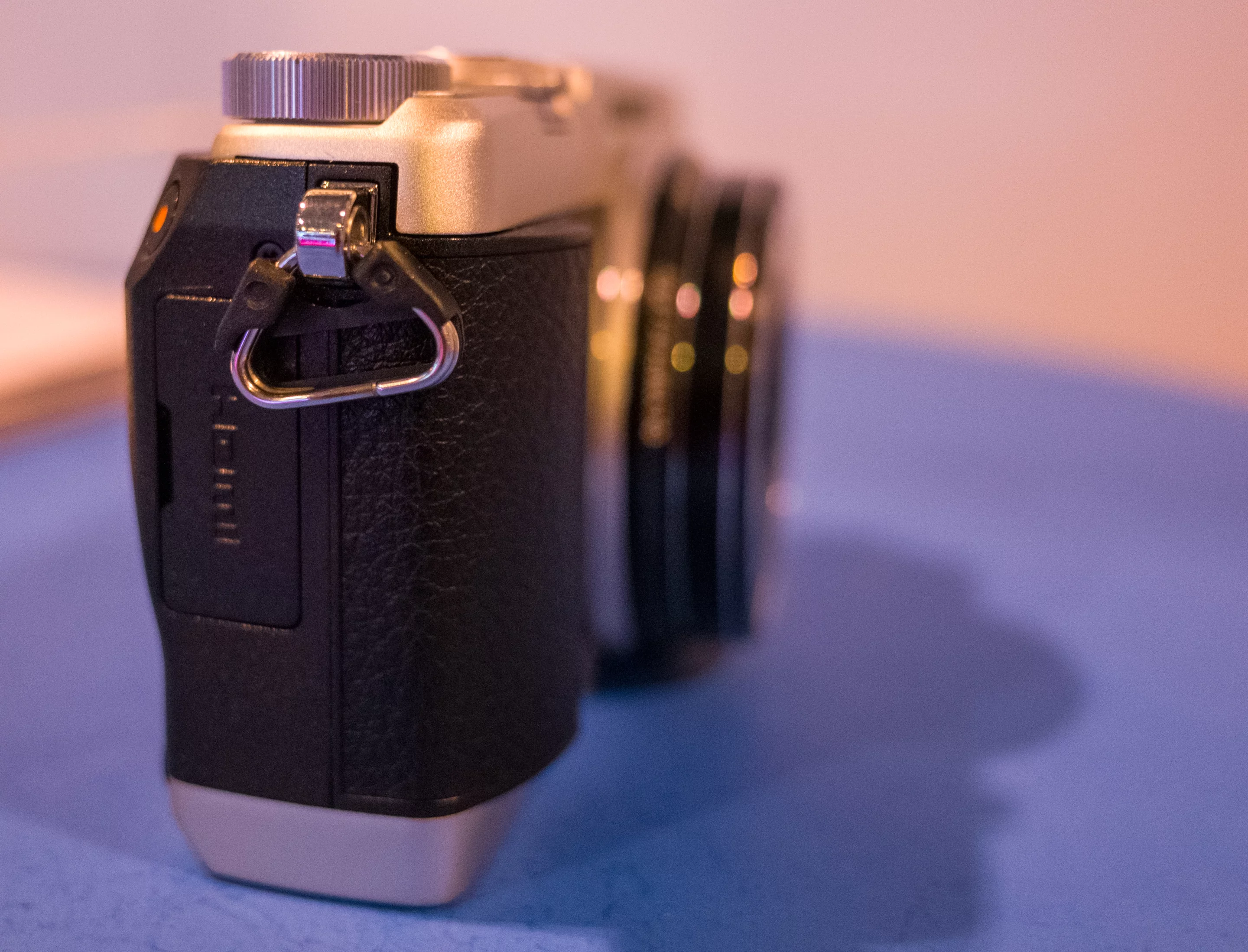 The Olympus Stylus has 5-axis image stabilization which helps when shooting with slower shutter speeds or long zooms