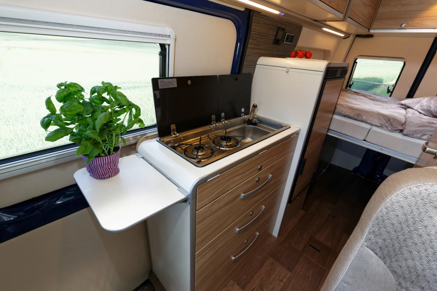 The Hymercar Grand Canyon S has a kitchenette with dual-burner stove, sink and storage