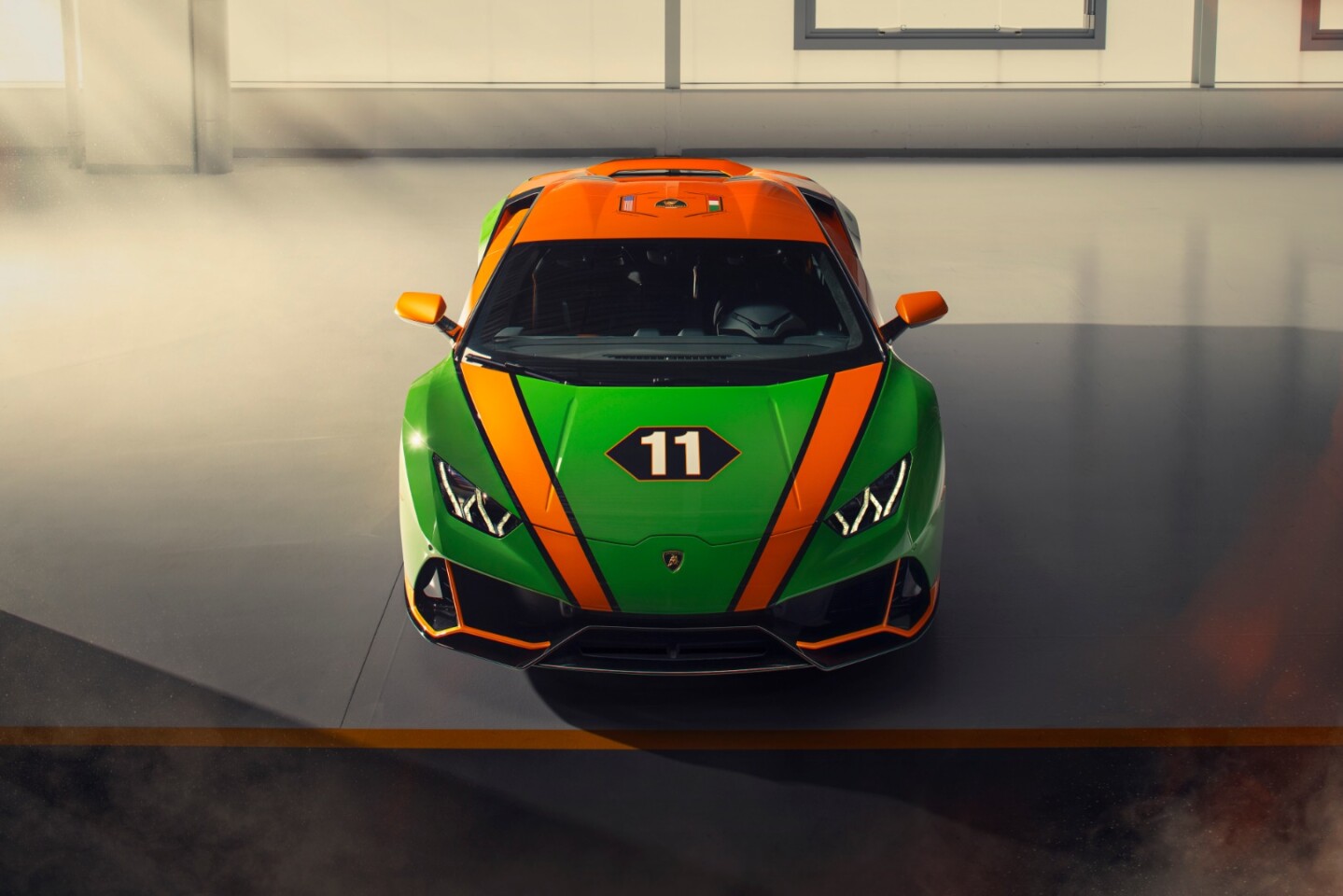 Livery in green and gold along with the winning car's number 11 are prominent on the Huracan EVO GT Celebration