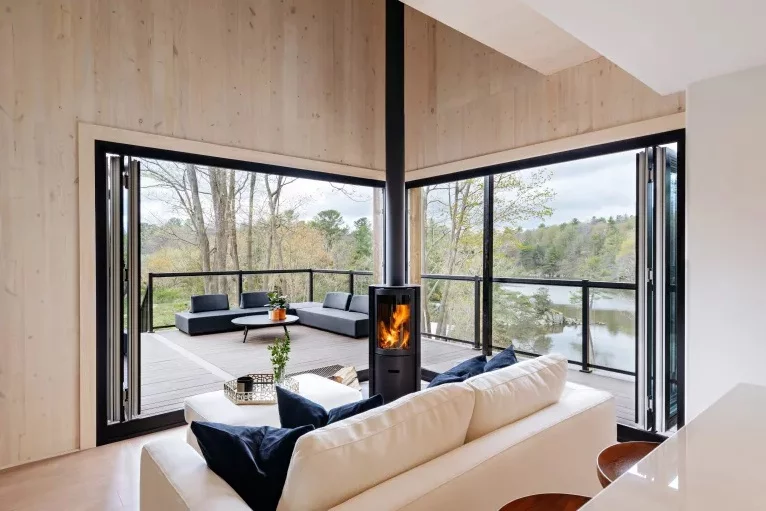 The one-bedroom SON.DER display home features an open living room with wood-fired combustion heater