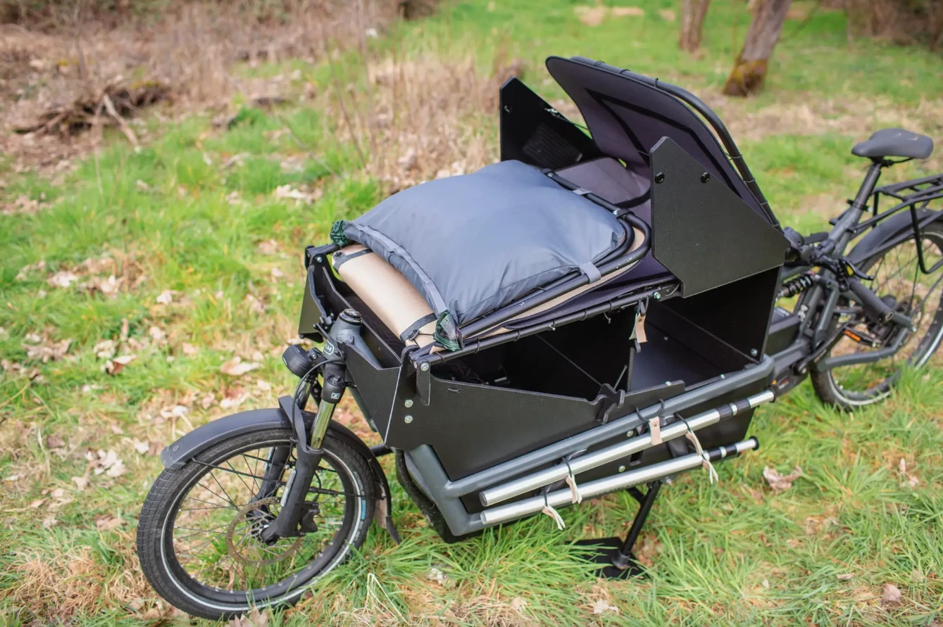 The tent and lounger folded and ready for travel - cyclists can easily fit a backpack loaded with clothes, gear and supplies atop the front and below the weatherproof cover