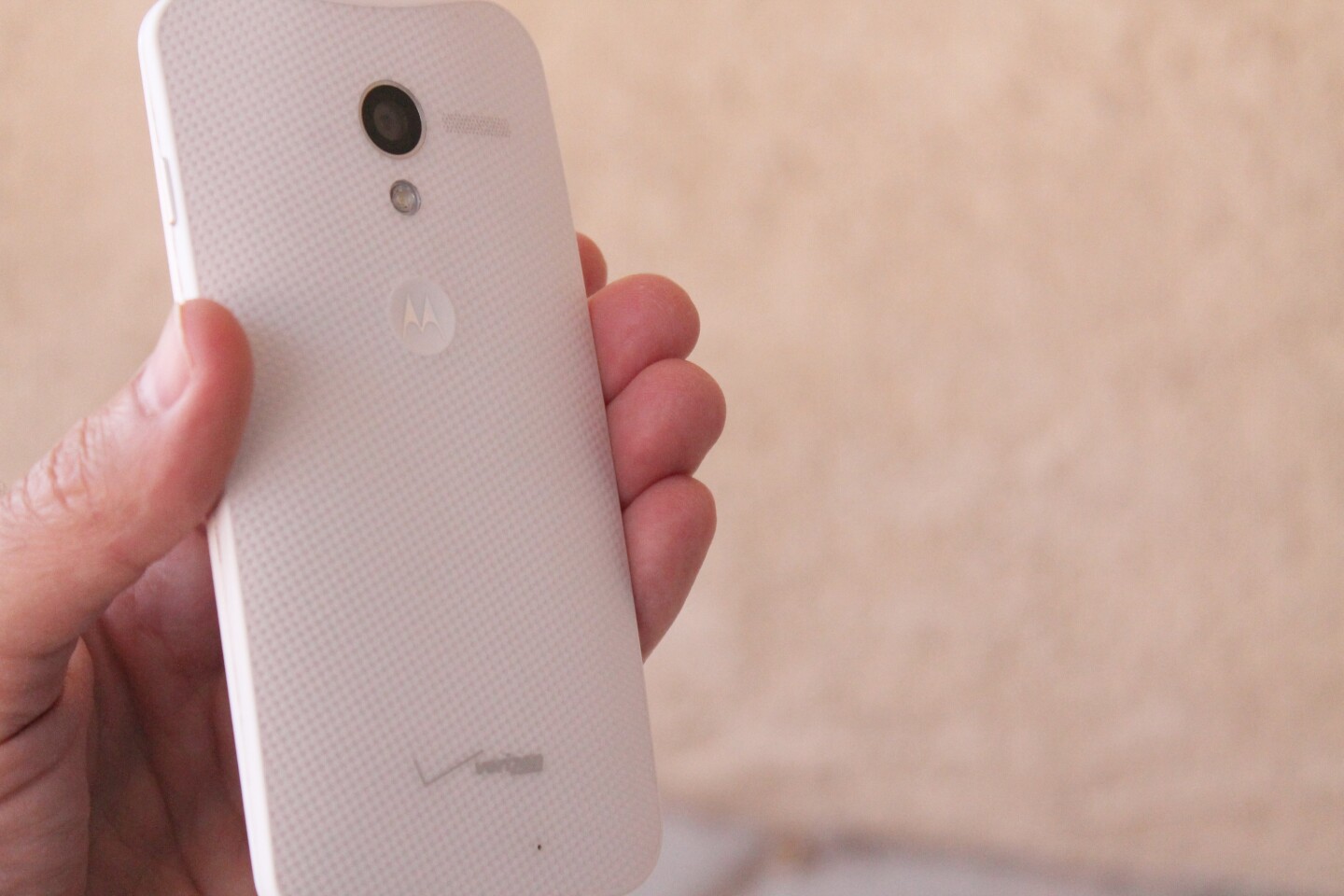 The Moto X has a dimple on its back, where the Motorola logo lies
