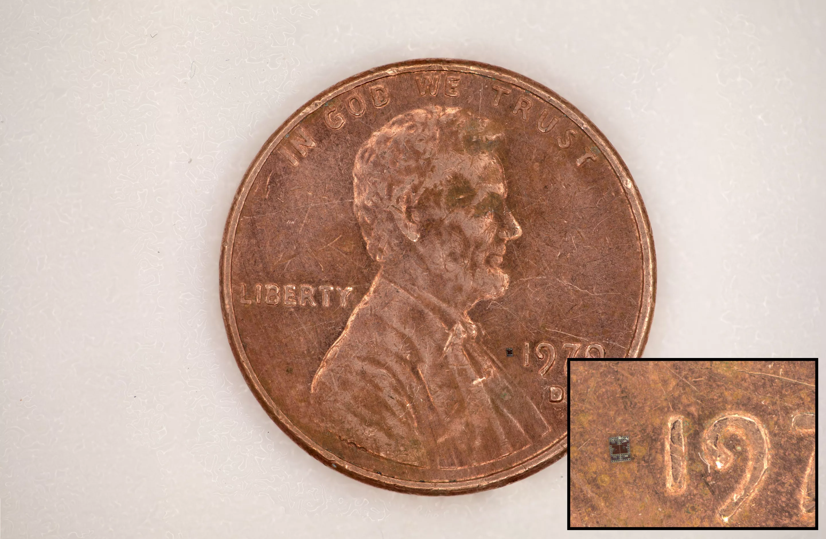 A microrobot, fully integrated with sensors and a computer, sitting on top of a US Penny, for scale