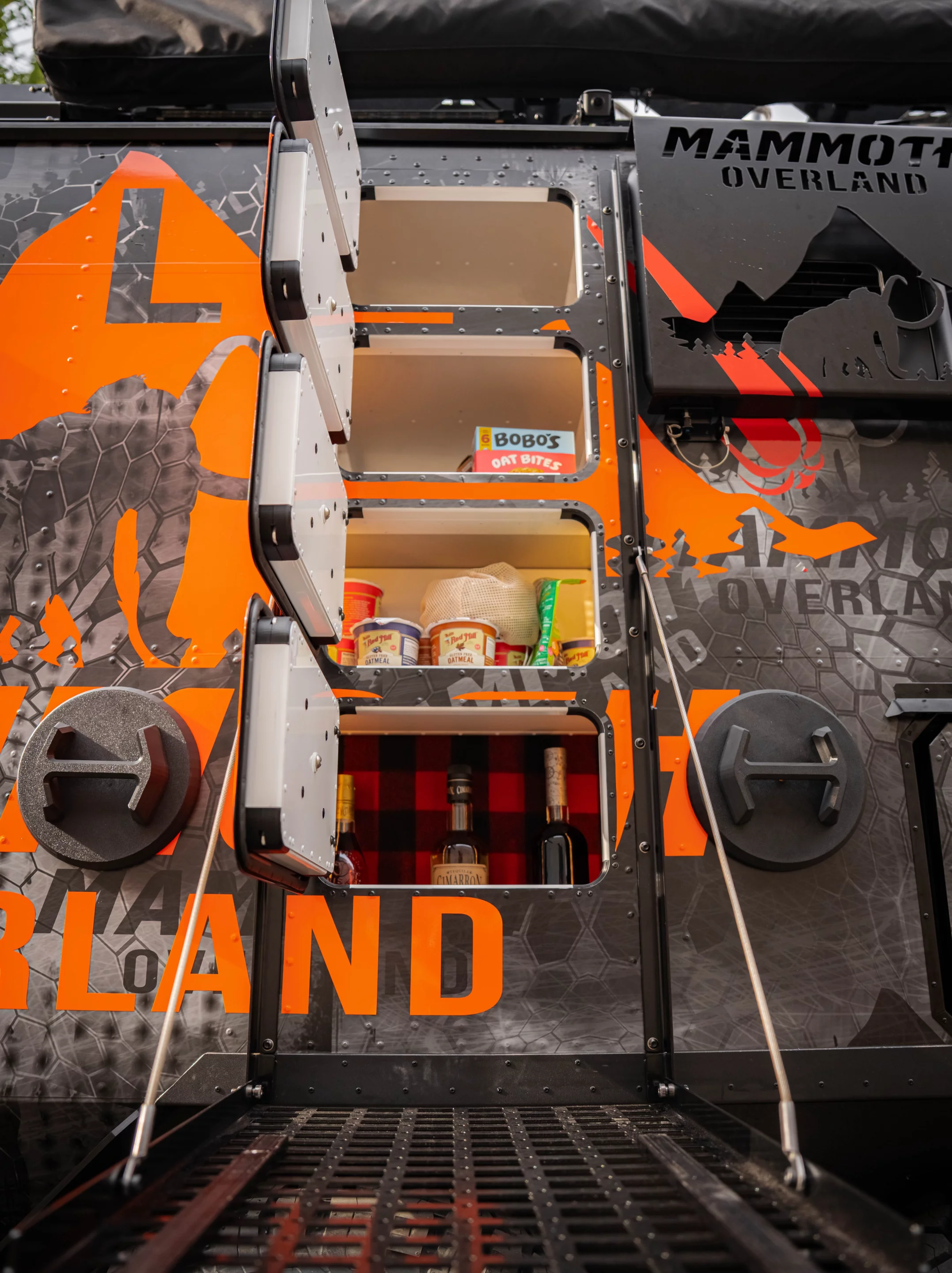 When the MOLLE panel drops down to work as a counter, it opens access to the indoor/outdoor pantry stack