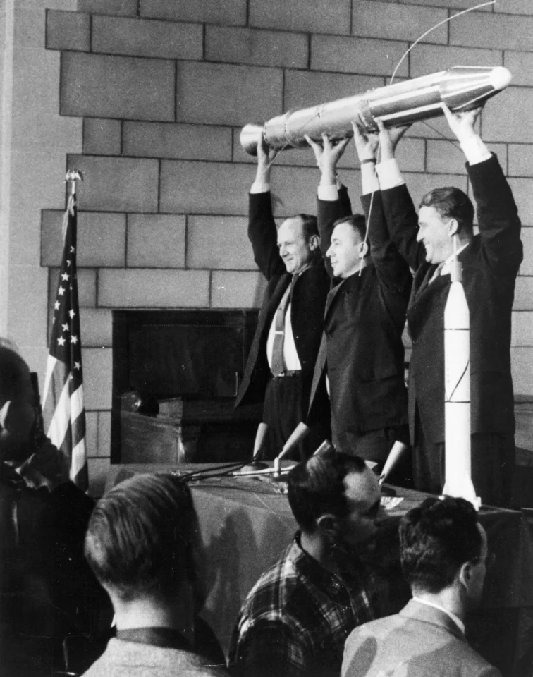 William H. Pickering, James Van Allen and Wernher Von Braun holding aloft a model of Explorer 1 at the post-launch press conference