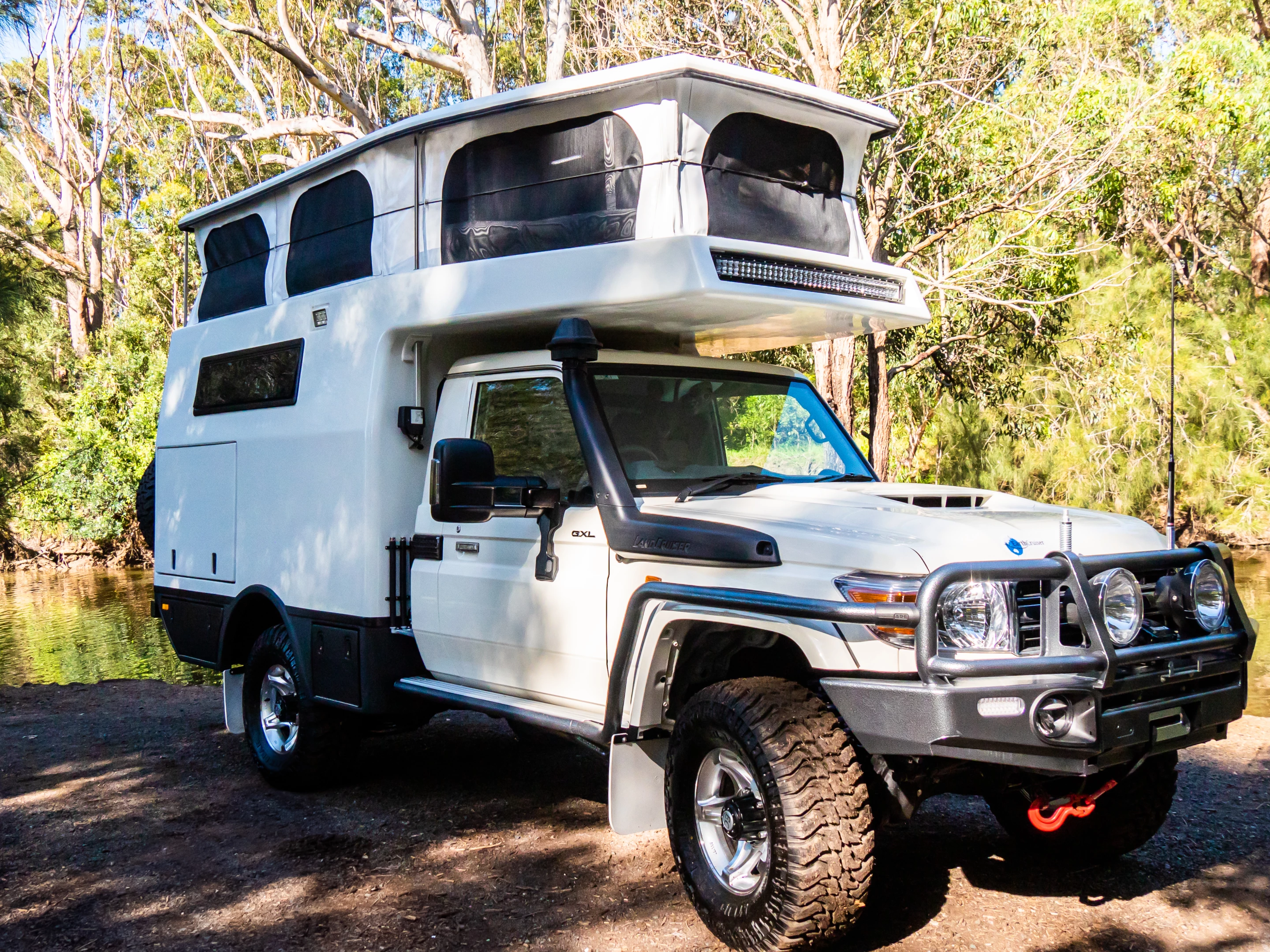 The EarthCruiser XTR250's roof lifts with a push-button electric actuator system