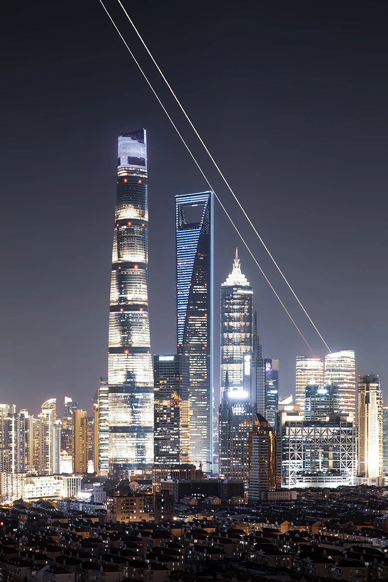 People & Space Runner-Up: Parallel Lines Over the City © Ran Shen (China). The paths of Venus and Jupiter streak across the city skyline of Shanghai.