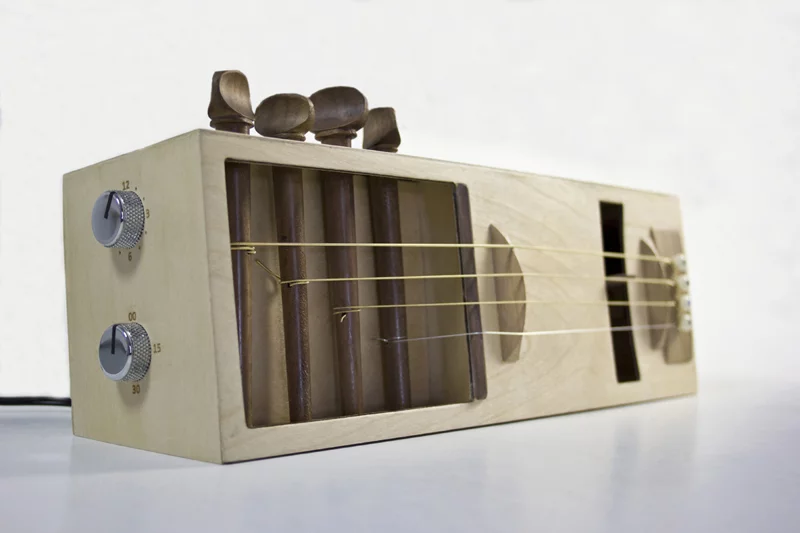 The Acoustic Alarm is a one-off alarm clock, that uses a motorized pic to pluck guitar strings in order to wake its user.