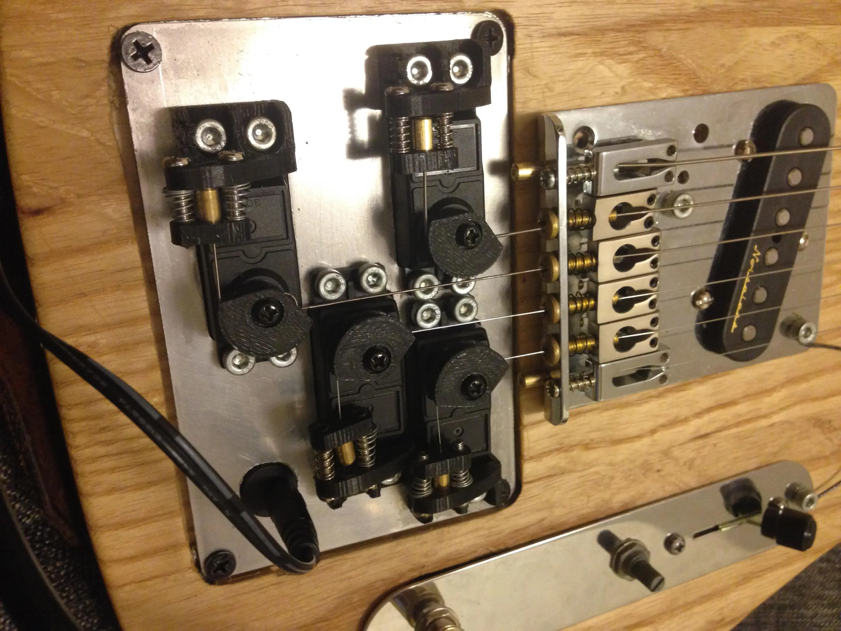 The servos are controlled by a cabled foot pedal via an Arduino running custom code