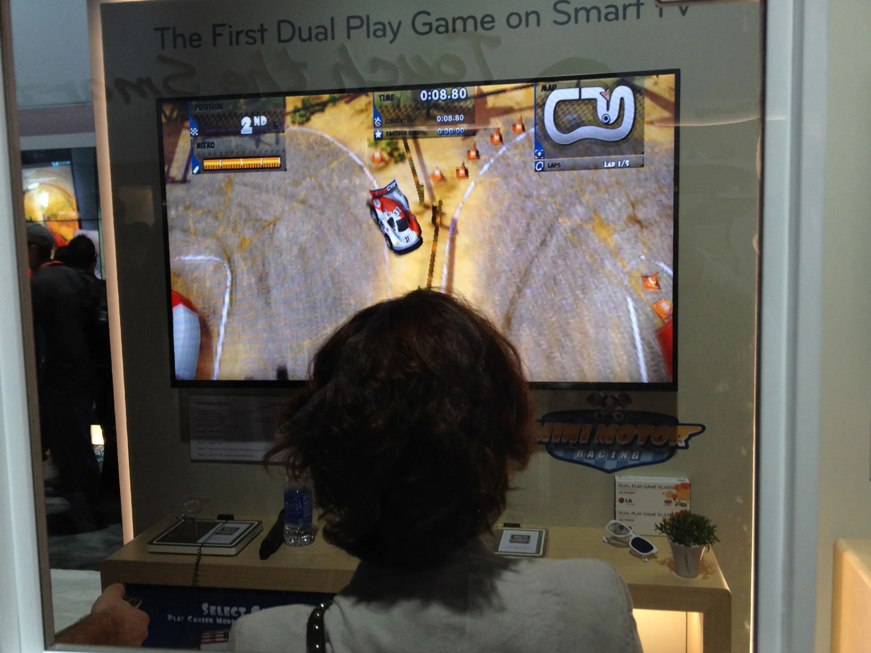 People playing LG's Dual Play game at CES 2013