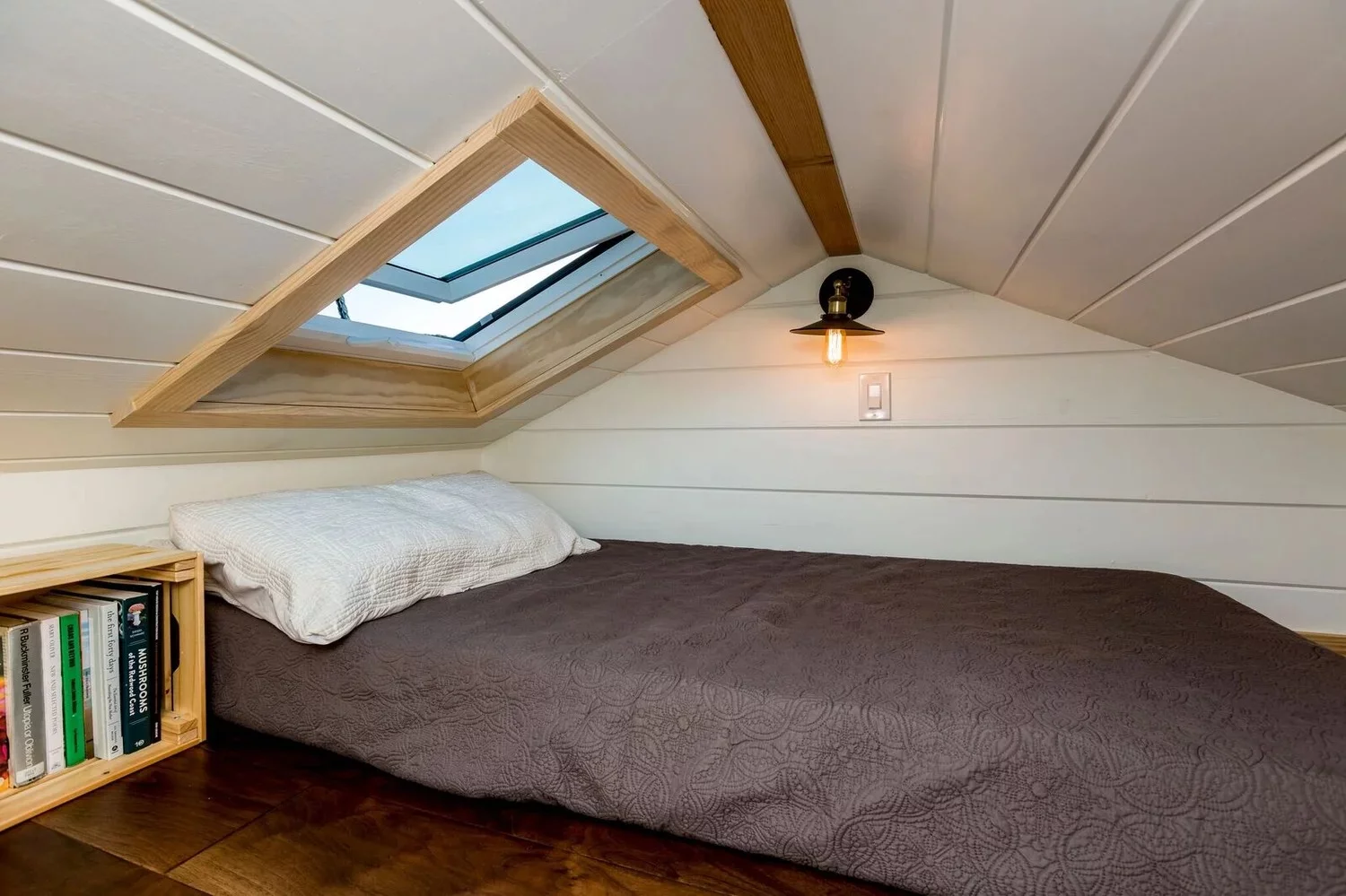 The Joshua Tree tiny house's bedroom is a typical loft model with a low ceiling