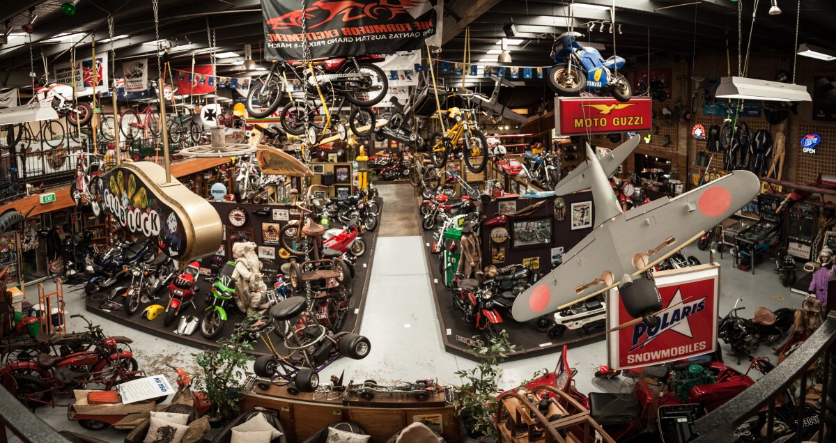Antique Motorcycles: model planes, minibikes, snowmobiles, odd bicycles and all sorts of other gear hang from the ceilings