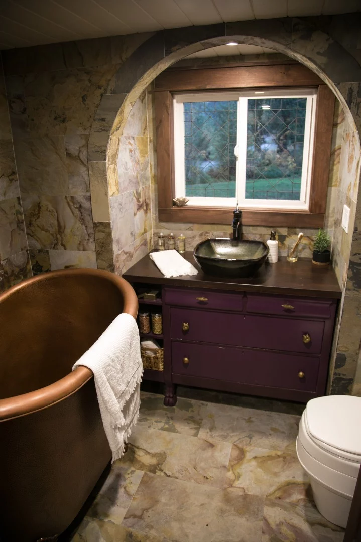 The bathroom includes a copper clawfoot bathtub