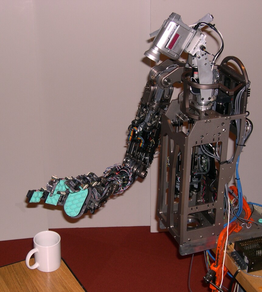 Torres-Jara's Obrero robot, seen here about to lift a ceramic mug