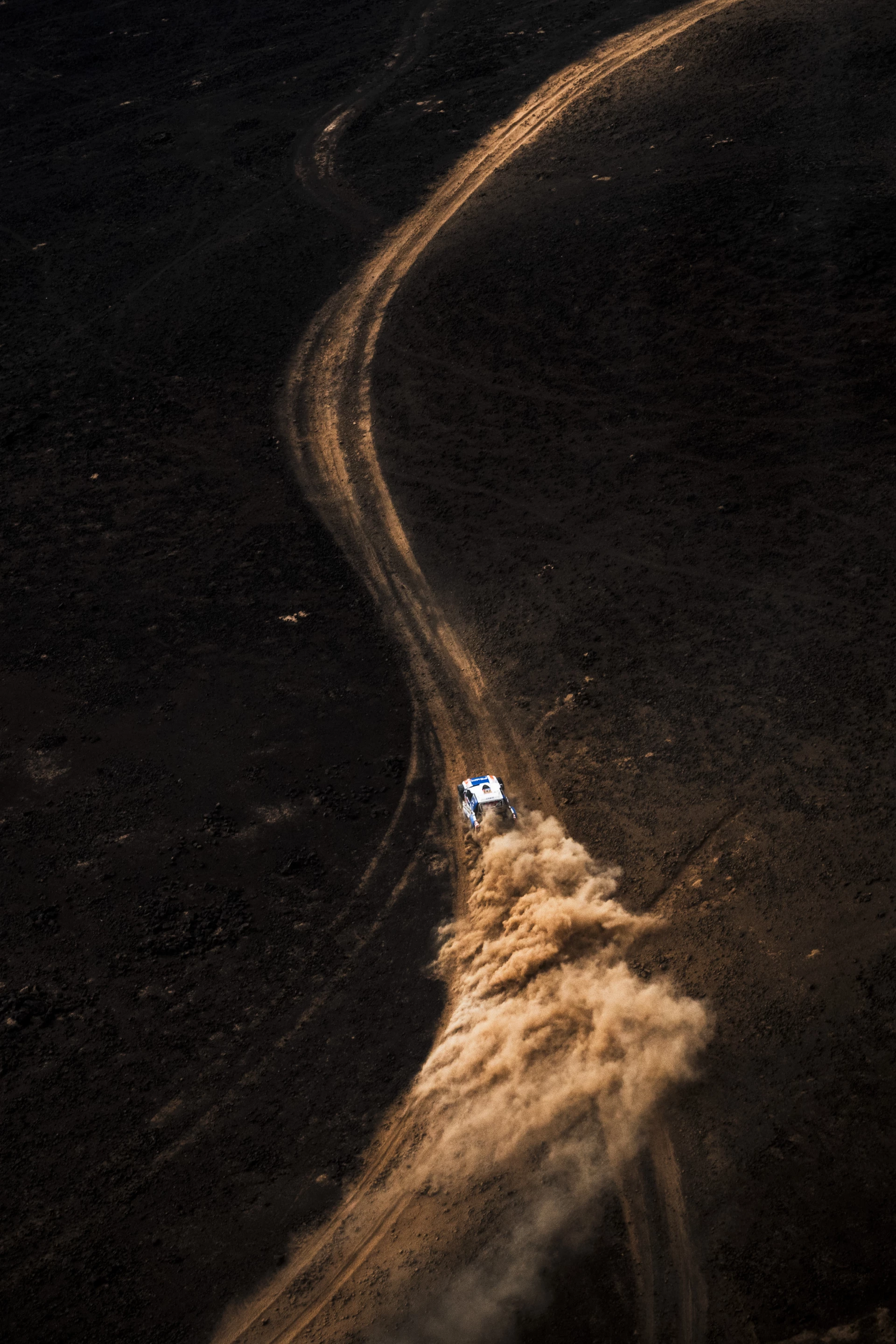 The stark contrast from tracks to certain flats, German duo Daniel Schröder (#242) and Henry Carl Kohnein, lay spray during Stage 4 their Volkswagen PS Laser Racing car. While they faced navigation issues throughout, they managed top 30 finish in the FIA W2RC Ultimate class
