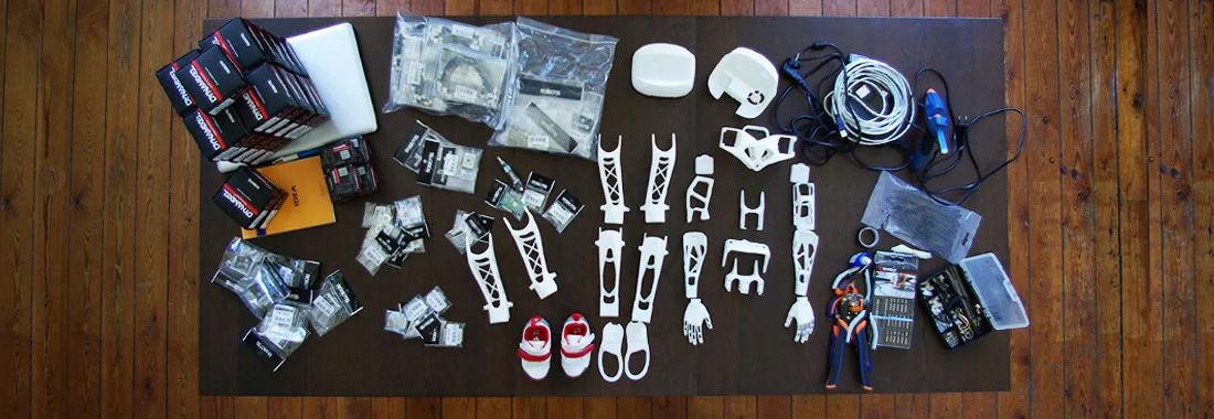 Poppy's 3D-printed parts alongside consumer electronics components (Photo: Inria / H. Raguet)