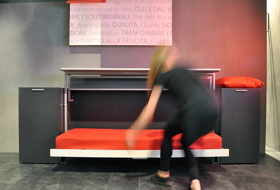 The cabinet pulls down, revealing a singe bed