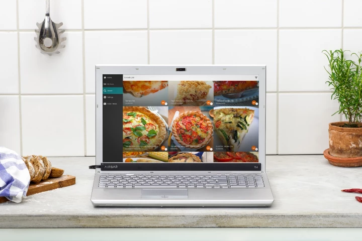 The AirBar mounts below the screen of a PC, via a magnetic strip