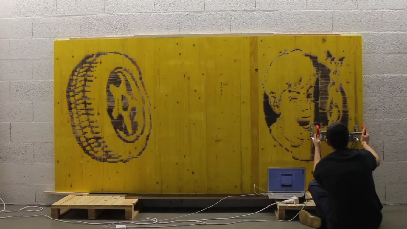 The FireWriter is a handheld printer that burns pictures onto wood with a torch, while an optical sensor keeps track of the image's positioning