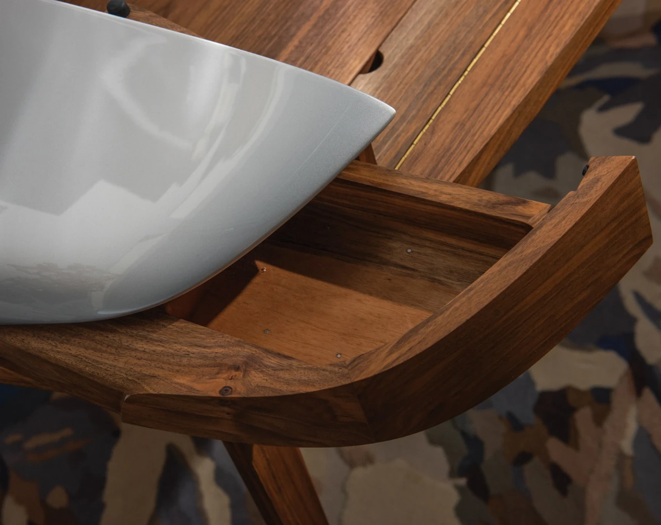The Porsche Writing Desk features two small drawers on either side of the center writing space for extra storage