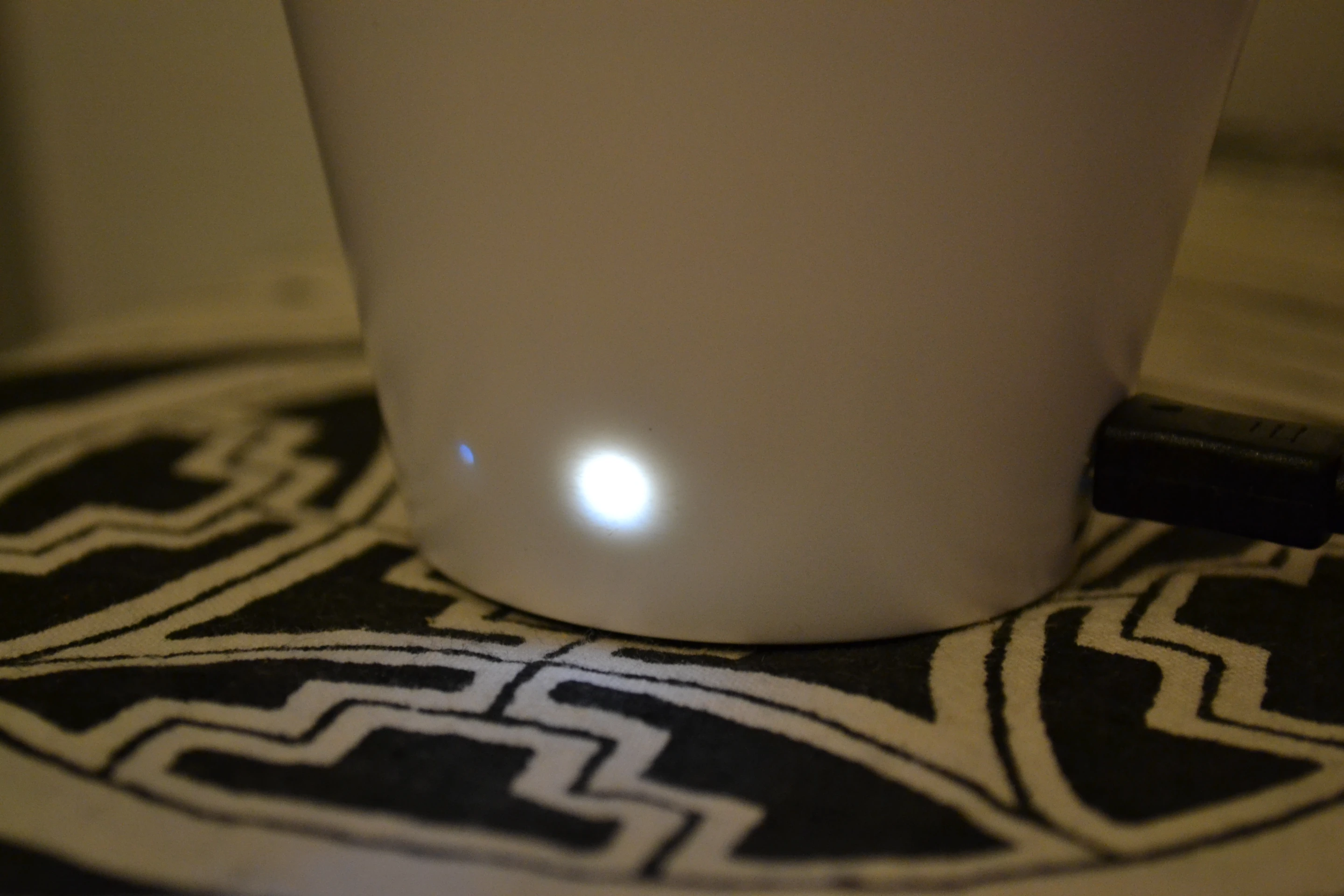 When the white LED next door lights up, the battery is being charged via the mini-USB input to the rear