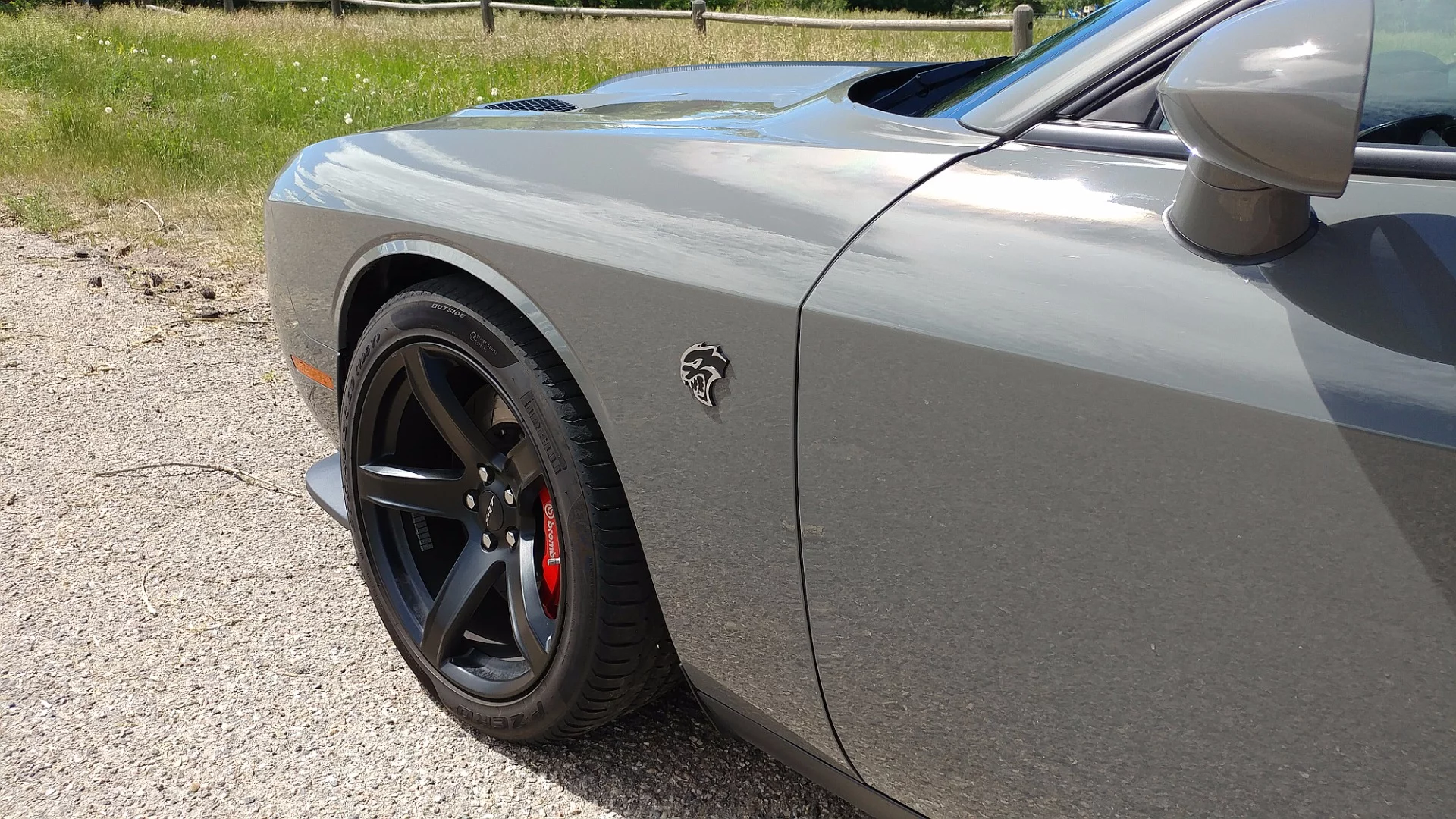 The small Hellcat emblems on the Challenger SRT Hellcat add to its muscular presence