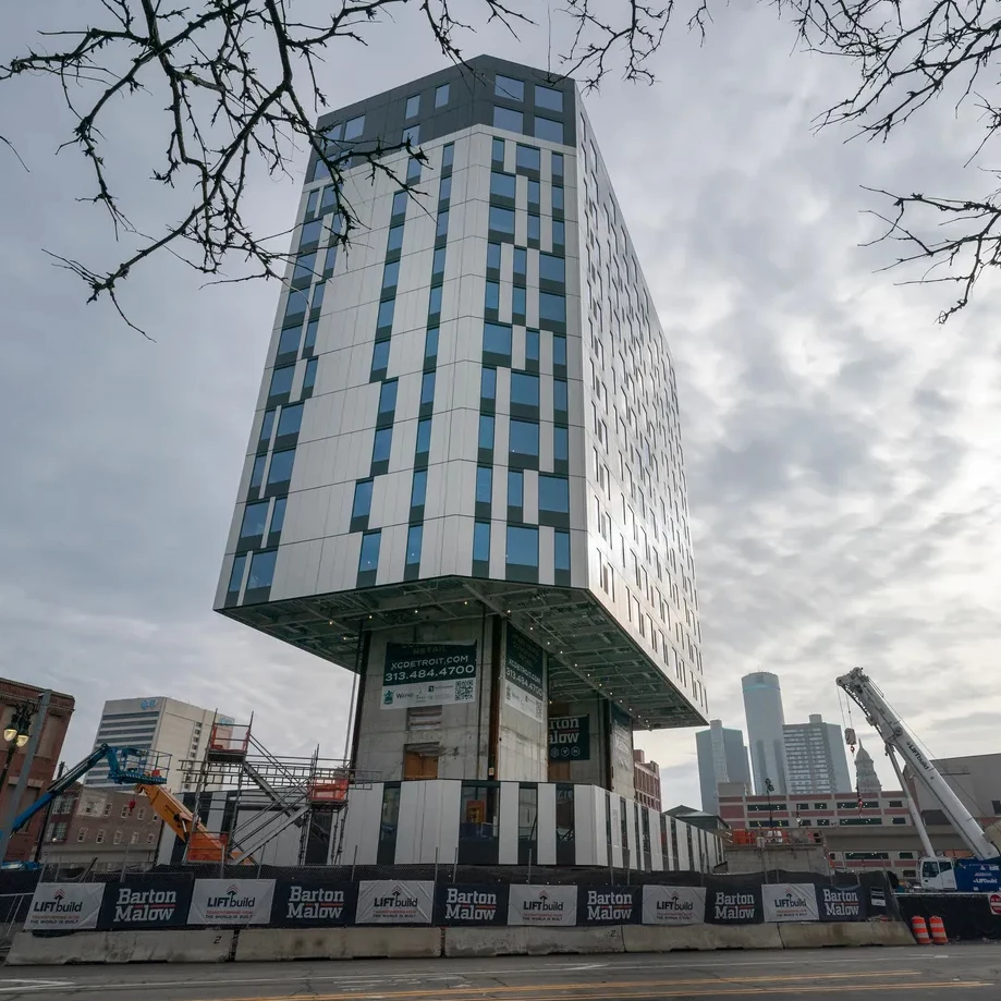 Entire floors are built close to the ground, around the building's two central cores, and they're then lifted up to be installed from the roof down
