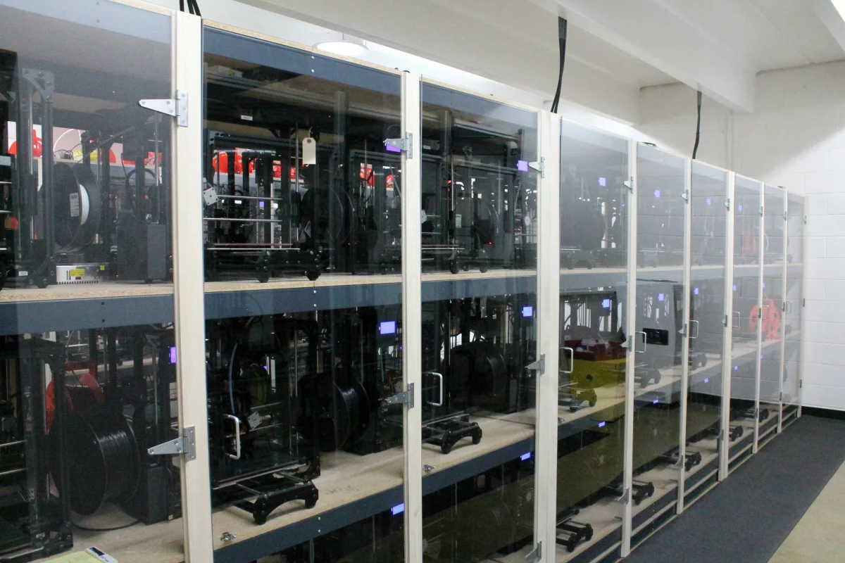 Lulzbot TAZ 3 printers line the cluster room four-deep and three-high