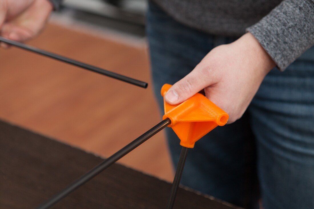 The Justin Case kayak's frame is made of a collection of carbon fiber poles, the ends of which the user inserts into a series of 3D-printed connectors