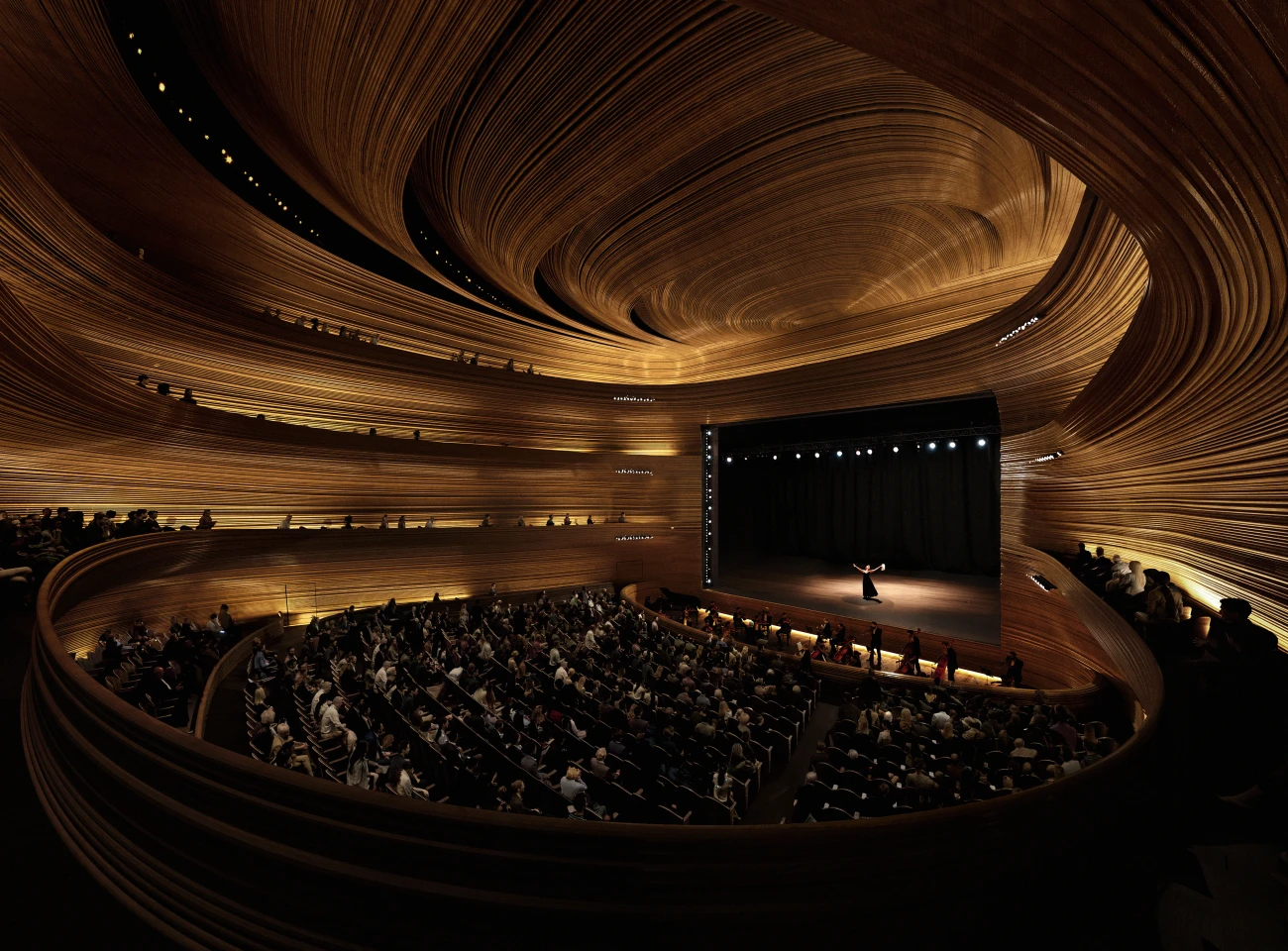 The Hamburg State Opera's main hall is envisioned as concentric circles of timber