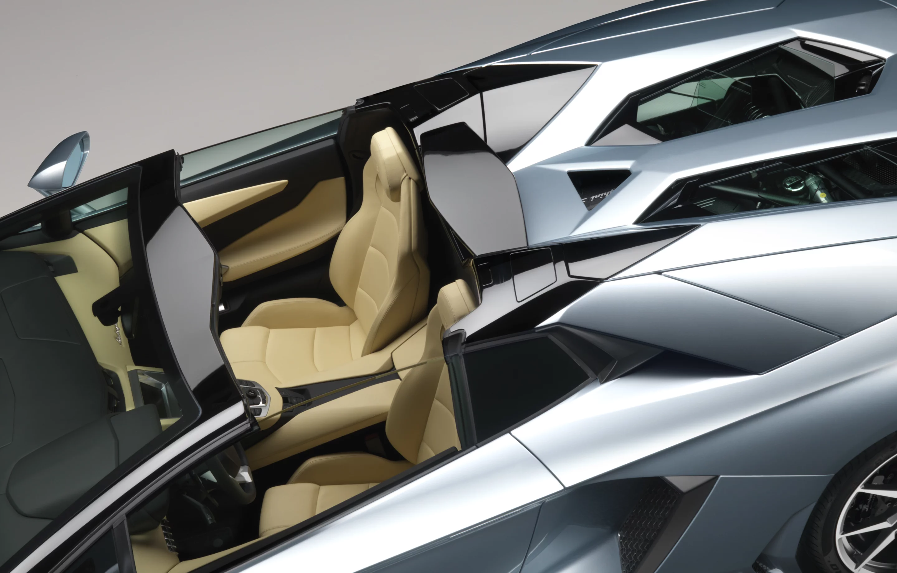The Lamborghini Aventador LP700-4 Roadster features hexagonal windows on the engine hood
