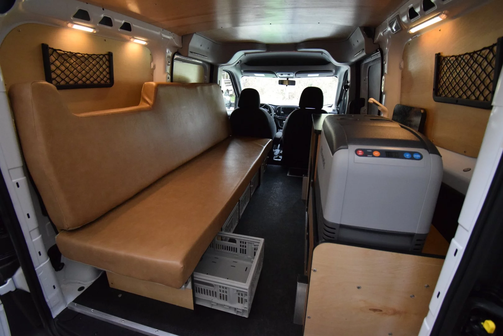 While compact, the Cascade camper van does include storage under and behind the sofa, via organizer pockets on the walls, and in the kitchen area