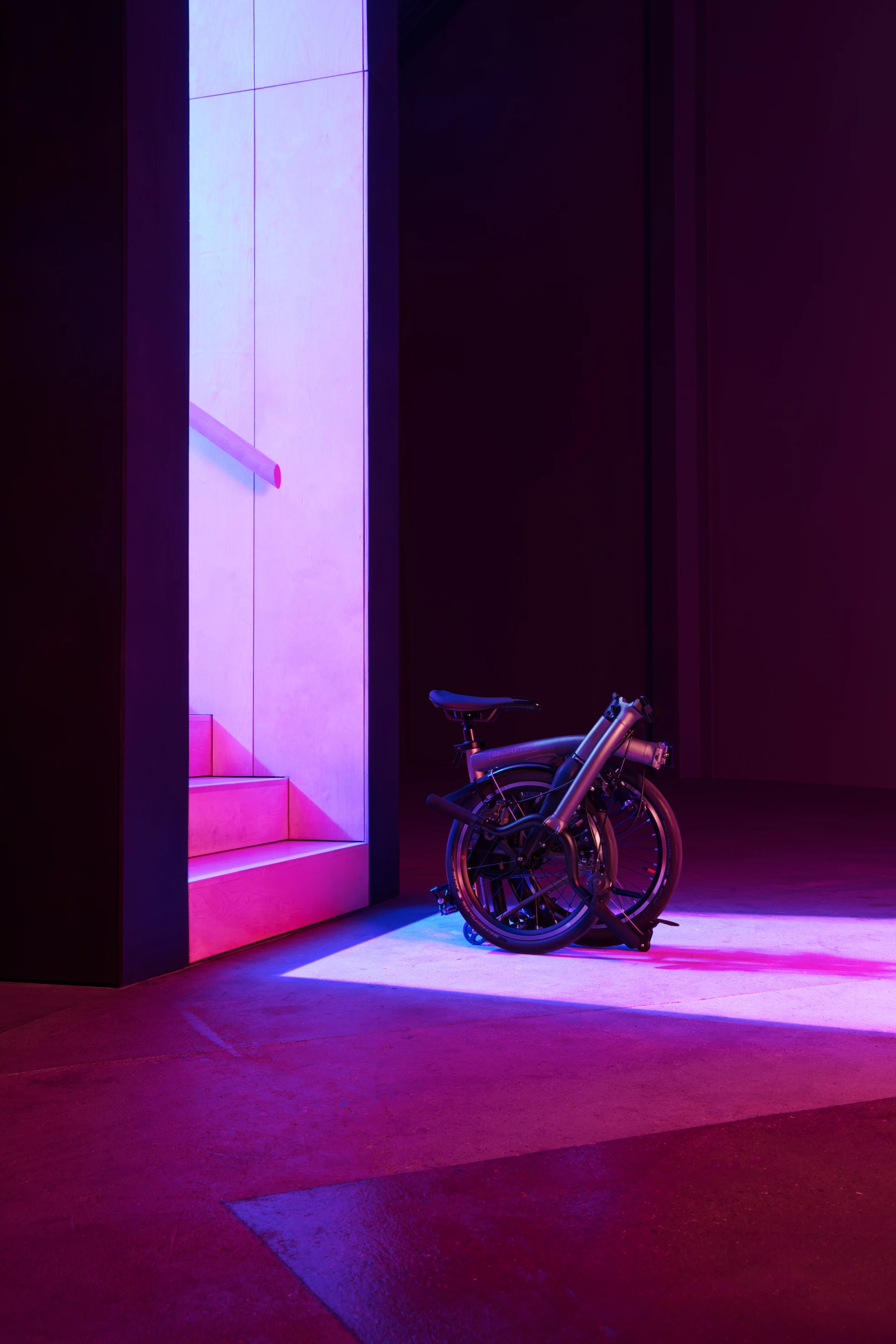 A redesigned folding mechanism includes self-aligning hinges and a spring-loaded handlebar catch