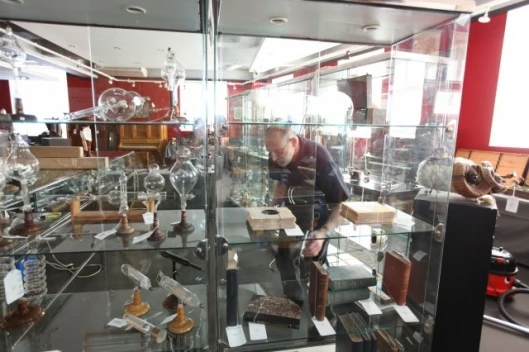 A cabinet full of rare scientific and early laboratory apparatus