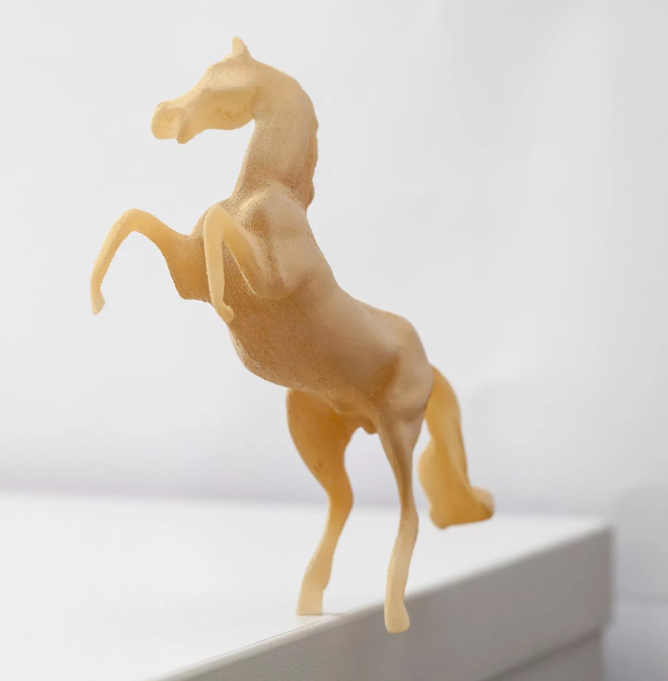 A model horse stands precariously on its hind leg thanks to Make It Stand